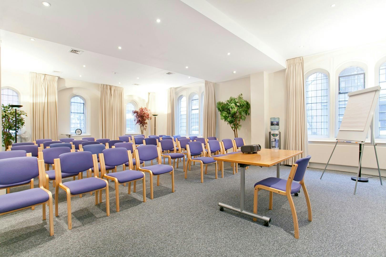 Trevelyan Hall meeting room with purple chairs, perfect for events and presentations.